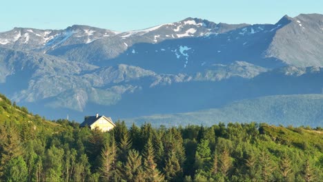 vacation cabin amidst lush foliage with mountain backdrop in bovaer, senja, norway