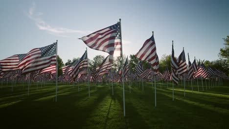 american flags at sunset slow motion low angle with sunbursts