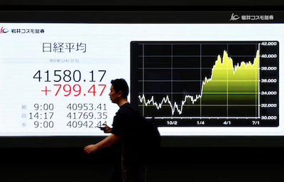 A man walks past an electric screen displaying Japan's Nikkei share average and a graph showing its recent movements outside a brokerage in Tokyo, July 9, 2024 REUTERS/Issei Kato/File Photo Purchase Licensing Rights