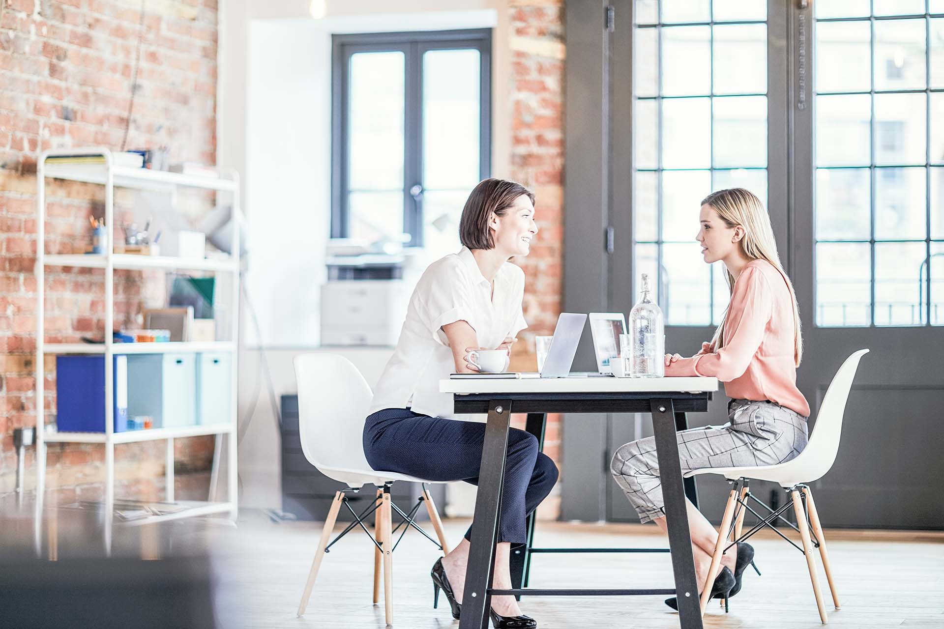 Two people having a meeting, currently in conversation