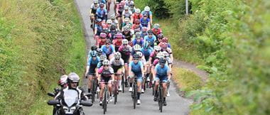 Racing cyclists, female, bunch, riding towards camera