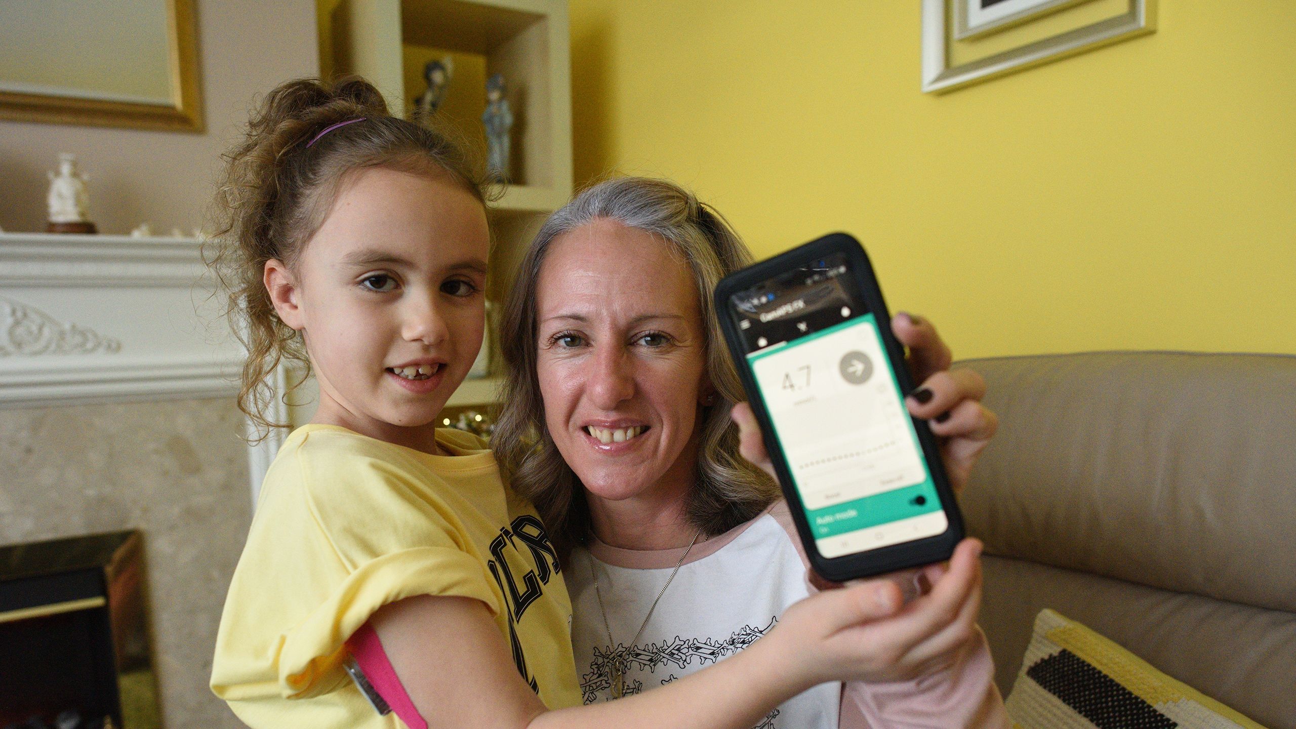 Sofia Wright (with mother Sam) showing the artificial pancreas app