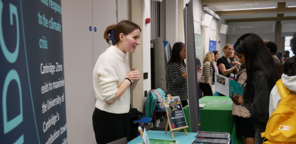 Cambridge stall is staffed by one person at Green Careers Fair talking to students