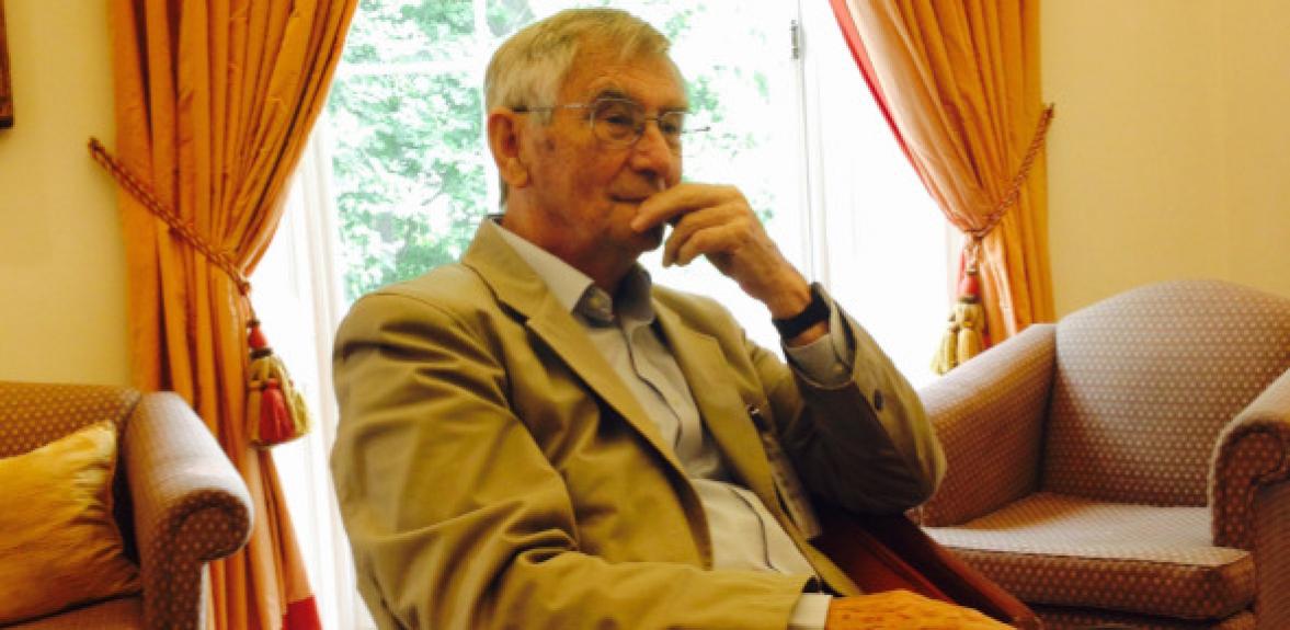 An older Jim Staunton sitting in an armchair looking thoughtful