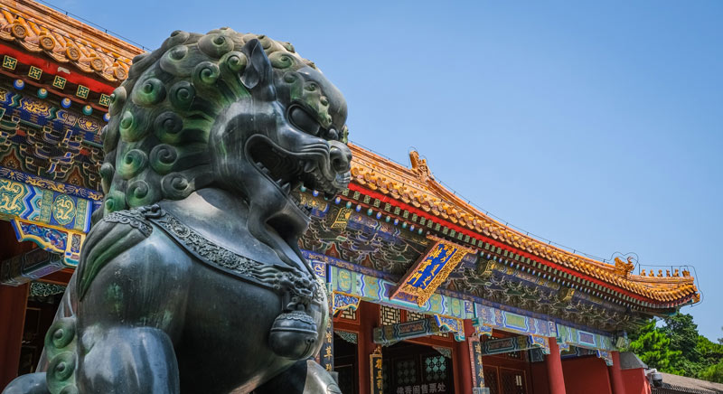 Foo Dog Statue in Front of Chinese Palace