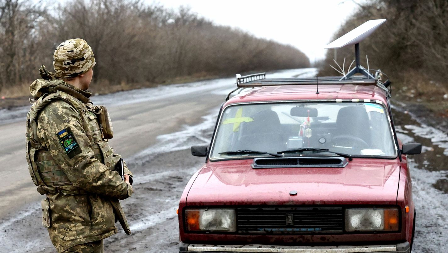 A Ukrainian serviceman stands next to a vehicle that carries a Starlink satellite internet system