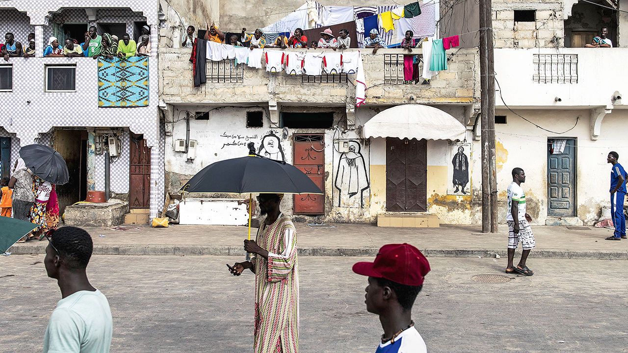 People stroll in the fishing village of Guet N'Dar in Saint-Louis, Senegal on July 23rd 2022