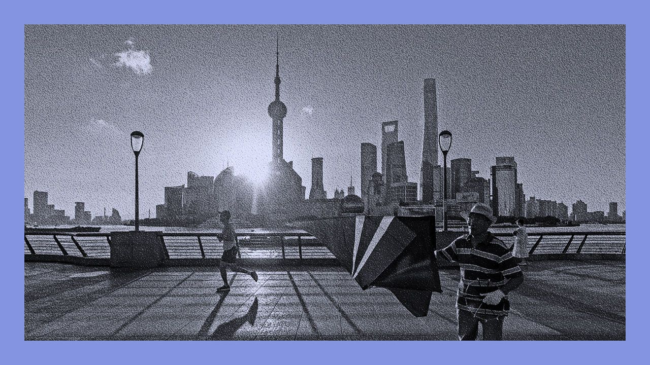 Pedestrians along the Bund across from commercial buildings in Pudong's Lujiazui Financial District in Shanghai, China