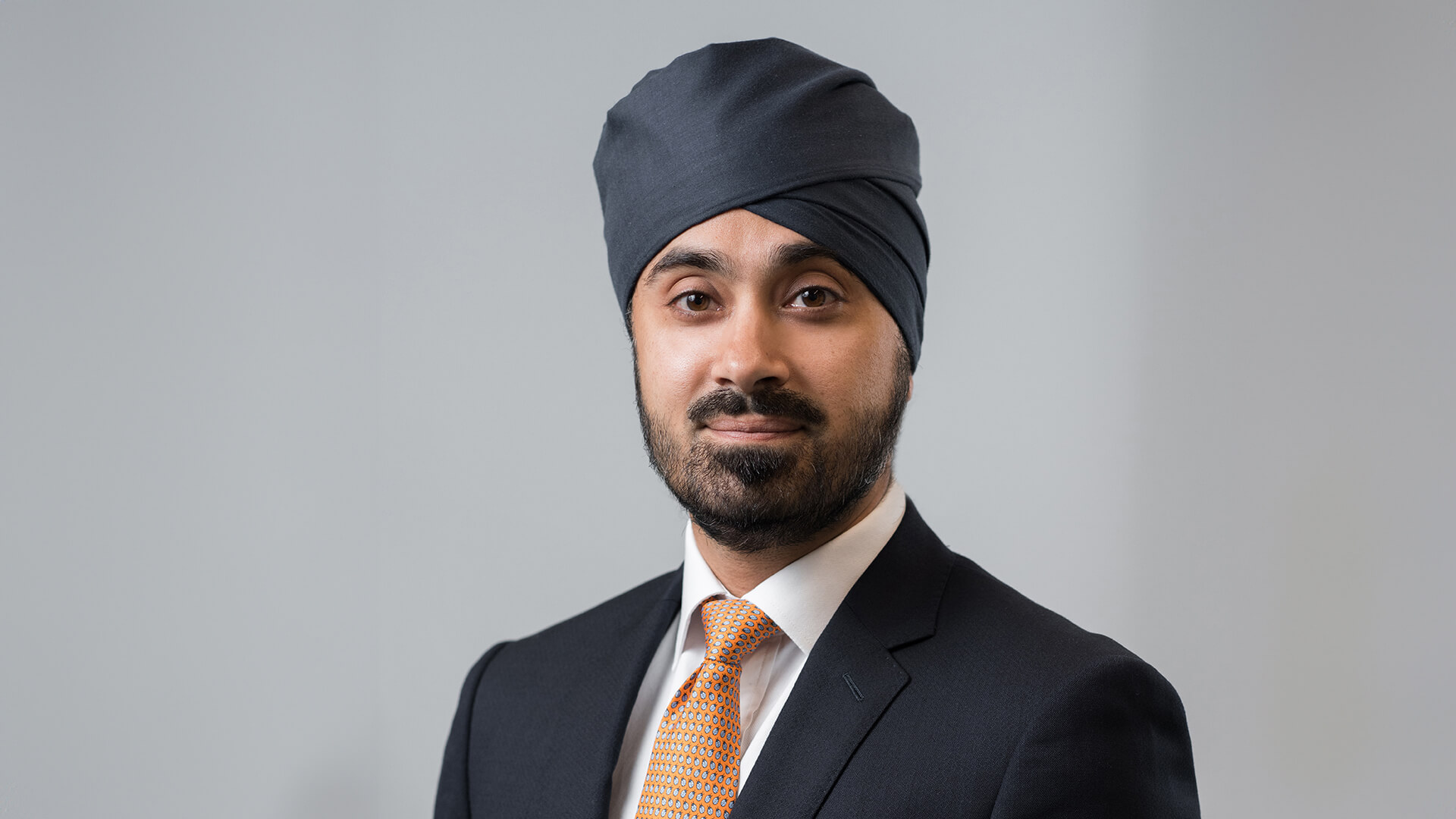 Head and shoulders photo of Gurpreet Gujral, set against a grey background