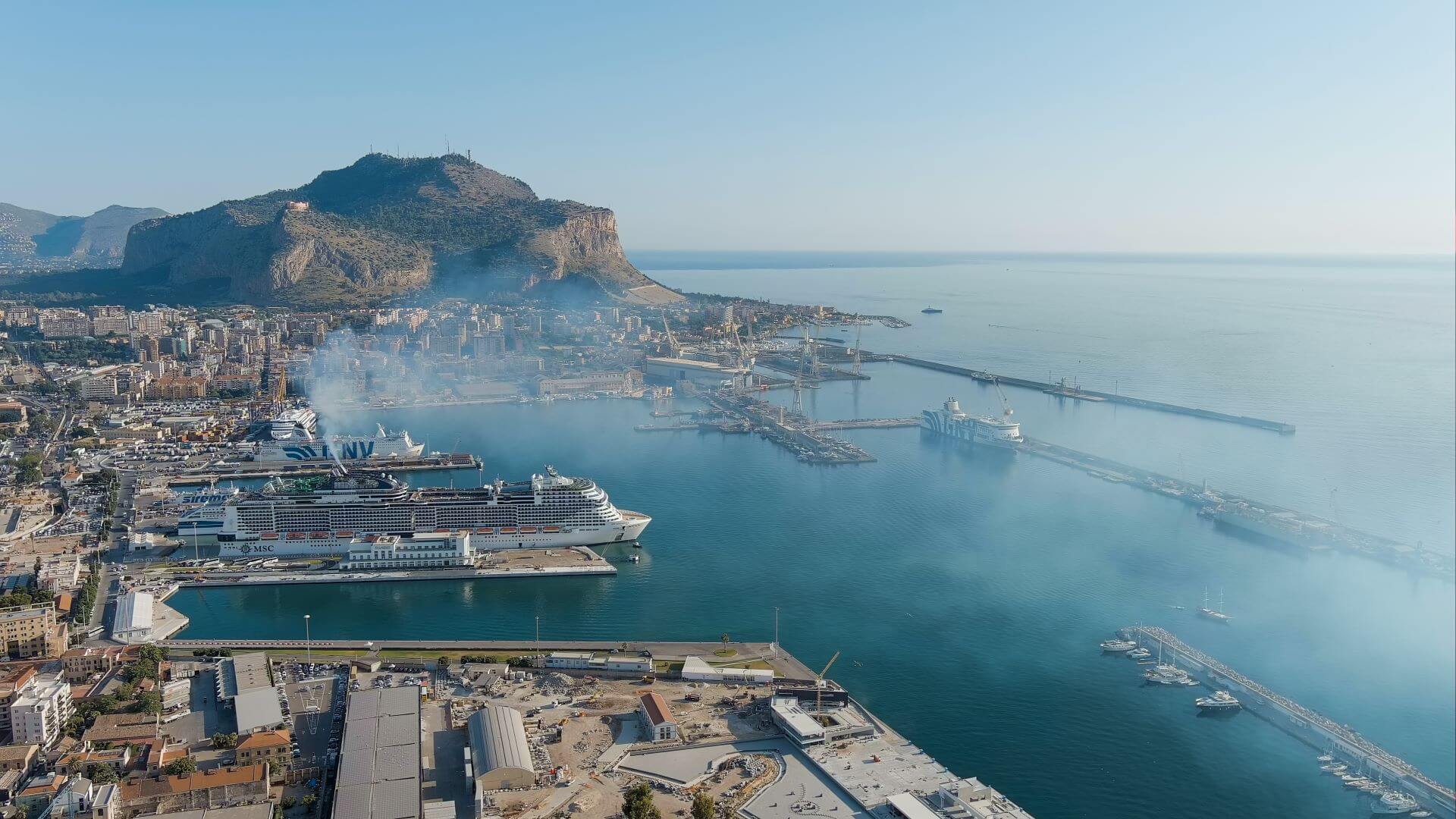 Aerial view of cruise ship in dock yard, emitting vapours from its chimney