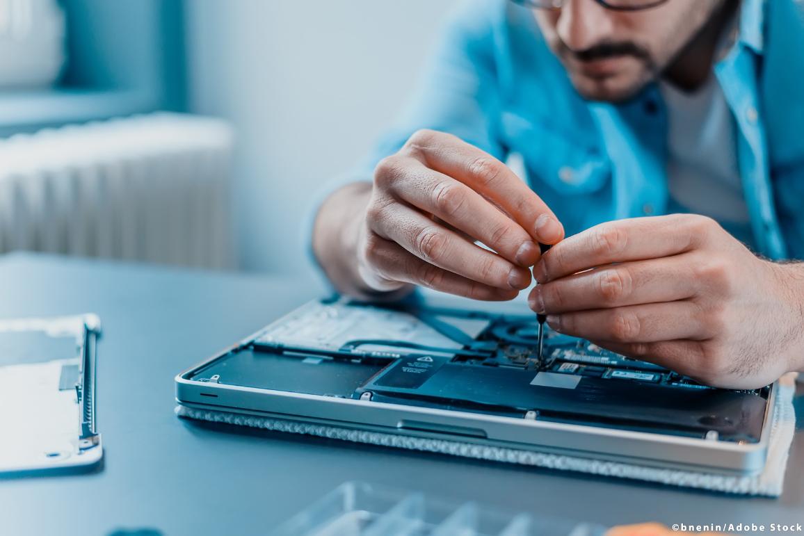 Close-up of laptop disassembling in repair shop.