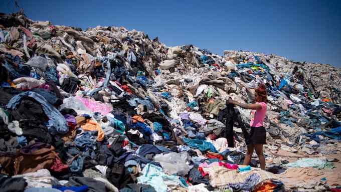 Women search for used clothes amid tons discarded in the Atacama desert