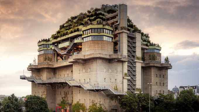 A concrete wartime bunker building topped with new floors covered in foliage