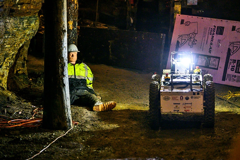 The robot navigates the test mine near a dummy.