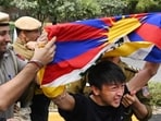 A protestor with Tibetan flag being shoved away by the police. (Vipin Kumar/ Hindustan Times)