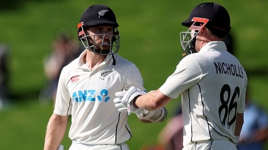 New Zealand's Kane Williamson (L) celebrators 50 runs with team mate Henry Nicholls during day two of the second cricket test match between New Zealand and Sri Lanka at the Basin Reserve in Wellington on March 18, 2023. (Photo by Marty MELVILLE / AFP)(AFP)