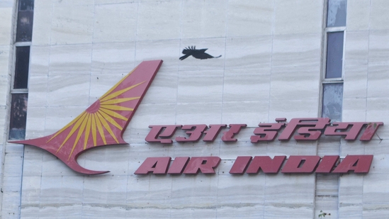 A bird flies over a logo of Air India airlines at the corporate headquarters in Mumbai, India.(REUTERS)