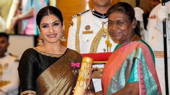 Raveena Tandon poses for pictures with President Droupadi Murmu as she presents the actor the Padmi Shri award for her contribution in films. (ANI)