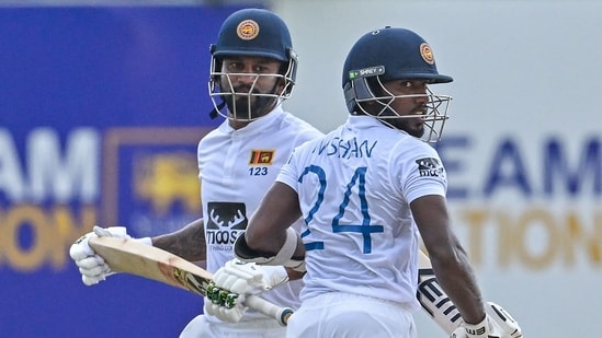 Sri Lanka's Dimuth Karunaratne (L) and Nishan Madushka run between the wickets during the second day of the second and final cricket Test match between Sri Lanka and Ireland at the Galle International Cricket Stadium in Galle on April 25, 2023. (Photo by Ishara S. KODIKARA / AFP)(AFP)