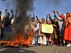 Imran Khan supporters chant slogans next to burning tires during a protest to condemn the arrest of their leader, in Hyderabad, Pakistan.(AP)