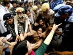 Ace wrestlers Vinesh Phogat, Sakshi Mallik and Bajrang Punia were among others who were detained by Delhi Police on Sunday while attempting to march to the new Parliament building where they planned to stage a demonstration.(Sanjeev Verma/ Hindustan Times)