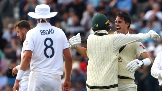 Australia's Pat Cummins (R) celebrates with Australia's Nathan Lyon after winning the first Ashes Test (AFP)