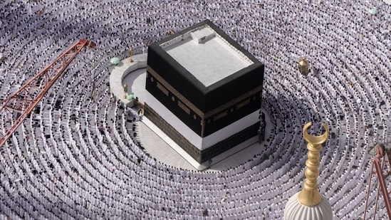 Muslim pilgrims pray around the Kaaba, the cubic building at the Grand Mosque, during the annual Hajj pilgrimage in Mecca, Saudi Arabia, on June 25. Muslim pilgrims are converging on Saudi Arabia's holy city of Mecca for the largest Hajj since the coronavirus pandemic severely curtailed access to one of Islam's five pillars.&nbsp;(Amr Nabil / AP)