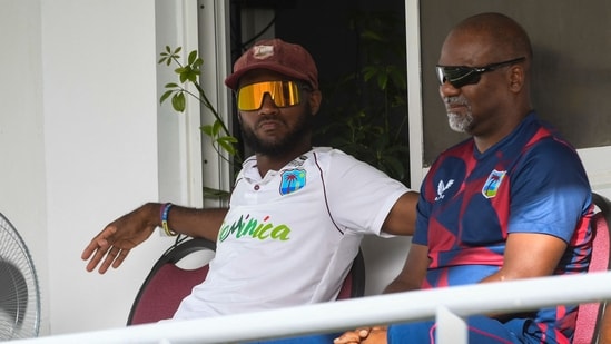 Kraigg Brathwaite (L) and coach Andre Coley (R) of West Indies(AFP)