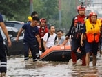 Rescue workers evacuate flood-affected residents using a boat after remnants of Typhoon Doksuri brought rains and floods in Beijing.(REUTERS)