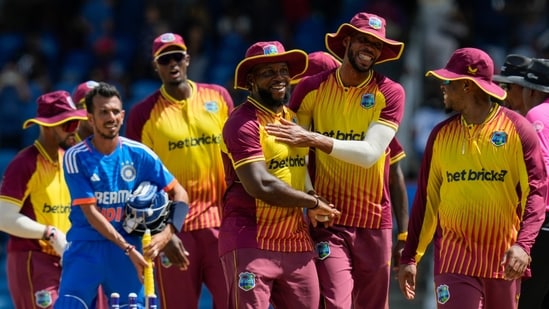 West Indies' Roston Chase, right, and Kyle Mayers embrace after defeating India for 4 runs(AP)