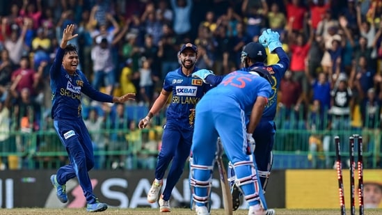 Sri Lanka's Dunith Wellalage (L) celebrates with teammates after taking the wicket of India's captain Rohit Sharma(AFP)