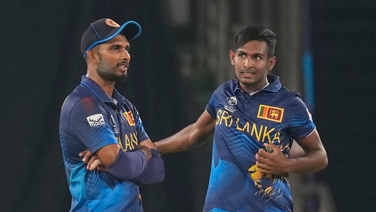 Sri Lanka's captain Dasun Shanaka, left, speaks to Matheesha Pathirana during the ICC Cricket World Cup match between Pakistan and Sri Lanka in Hyderabad(AP)