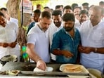 Congress leader Rahul Gandhi on Friday tried his hand at making a dosa at a roadside eatery in Telangana's Jagtial district.(PTI)