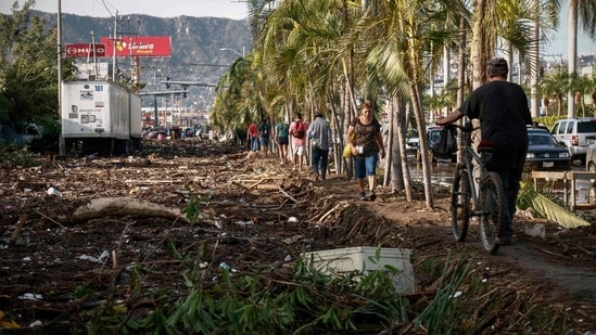 Survivors of a Category 5 storm that killed at least 27 people spent Thursday searching for acquaintances and necessities and hoping that aid would come quickly in the wake of Hurricane Otis.&nbsp;(AFP)