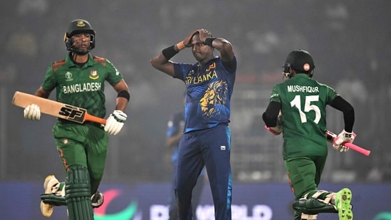 Bangladesh's Mahmudullah (L) and Mushfiqur Rahim run between the wickets as Sri Lanka's Angelo Mathews (C) watches during the 2023 ICC Men's Cricket World Cup one-day international (ODI) match (AFP)