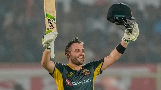 Josh Inglis celebrates after scoring a century during the first T20 cricket match between India and Australia.(AP)