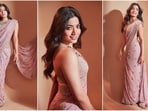 Rashmika Mandanna is currently gearing up for the release of her upcoming film Animal and her gorgeous back to back promotional looks in breathtaking sarees are stealing our hearts. The beautiful actress is a total stunner and can pull off any look to perfection whether it's a casual dress or a traditional suit. Earlier she sizzled in a lovely black saree and this time in a light pink gold work adorned saree, she proves her fashion finesses. With the wedding season upon us, Rashmika's saree looks will definitely inspire your ethnic wardrobe. Scroll down to take some fashion notes.(Instagram/@rashmika_mandanna)