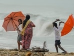 Locals visit the Marina Beach as high tidal waves lash the shore owing to Cyclone Michaung in Chennai, (PTI)