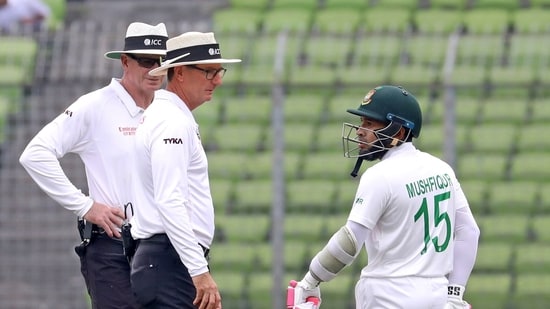 Bangladesh's Mushfiqur Rahim talks to umpires after he was declared out for obstructing the filed(AP)