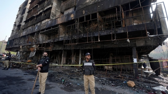 The death toll from the fire, initially at four, has now risen to five as rescue personnel recovered another body from the fire-affected residential building. (AP)