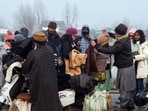 People buy warm clothes from the roadside after the city experienced the coldest night of the season in Srinagar.(ANI)