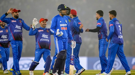 Afghanistan's players celebrate the wicket of India's batter Rohit Sharma 