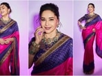 Madhuri Dixit is the ultimate queen of saree fashion, who always hits the ethnic fashion targets like a pro. The gorgeous actress is a total stunner and often turns heads with her elegant and sartorial looks. Just a day ago, Madhuri wowed her fans in a yellow mirrored work saree and this time she effortlessly rocked a vibrant purple and pink saree. Madhuri is quite active on social media and her glamorous Insta-diaries filled with stylish ethnic looks are a treasure trove of fashion inspiration for all her fans. Her latest look, draped in six yards of grace, exudes royal vibes and is sure to win your heart(Instagram/@madhuridixitnene)