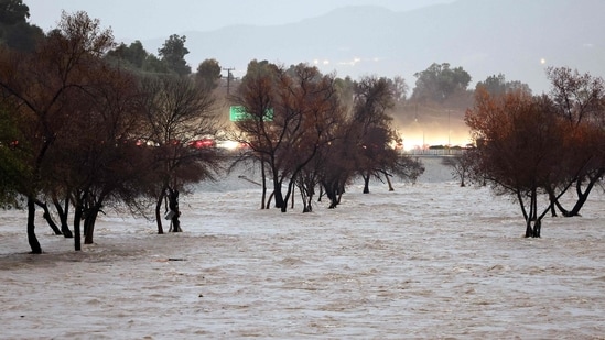 The Los Angeles River flows while swollen by storm runoff as a powerful long-duration atmospheric river storm, the second in less than a week, continues to impact Southern California on February 5.(Getty Images via AFP)