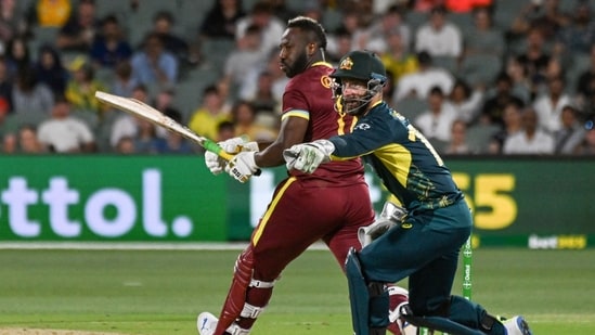West Indies' Andre Russell plays a shot next to Australia's wicket-keeper Matthew Wade (AFP)