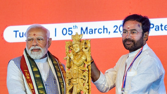 PM Narendra Modi being felicitated by Union Minister G Kishan Reddy during foundation stone laying and inauguration of various projects in Sangareddy.(PTI)