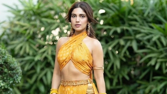 Bhumi Pednekar recently attended a wedding and shared on Instagram all the stunning looks she donned for the festivities. The actor's most recent post shows her dressed in a mustard yellow Bandhani print cropped blouse and skirt set. It is the must-have Haldi outfit you need this shaadi season. Scroll through to check out Bhumi's pictures. (Instagram)