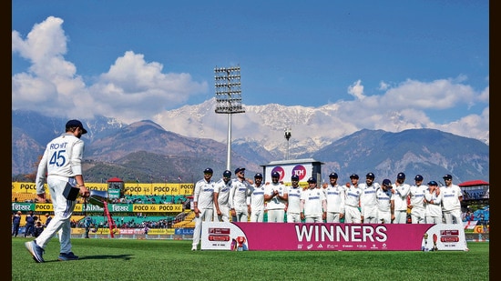 Indian cricket team captain Rohit Sharma (L) with the trophy joins his teammates after the Test in Dharamsala on Saturday. (PTI)