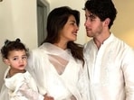 Pictures and videos of Priyanka and Nick celebrating Holi went viral on social media. In the first picture, Priyanka can be seen wearing a white anarkali suit with black bindi and held Malti in her arms. Nick wore a white kurta set and can be seen standing behind them as they pose for a family picture.(Instagram)