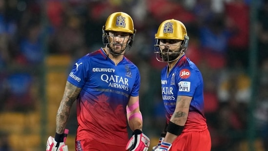 Royal Challengers Bengaluru's Virat Kohli, right, stands between the wickets with captain Faf du Plessis(AP)